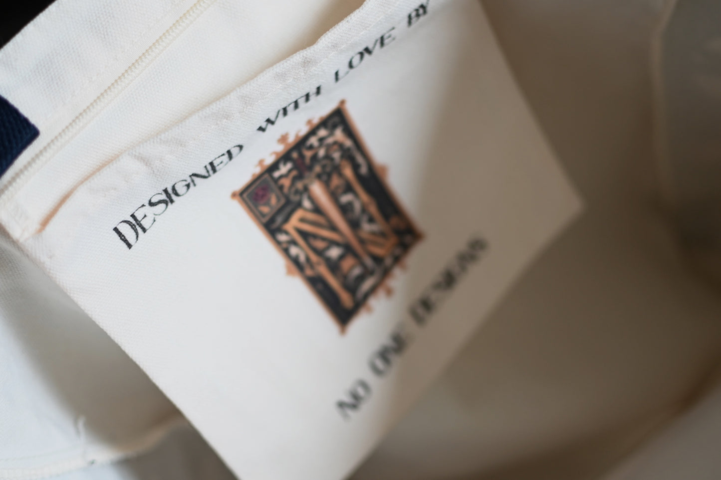 Close-up of a label on a garment with text and a logo.