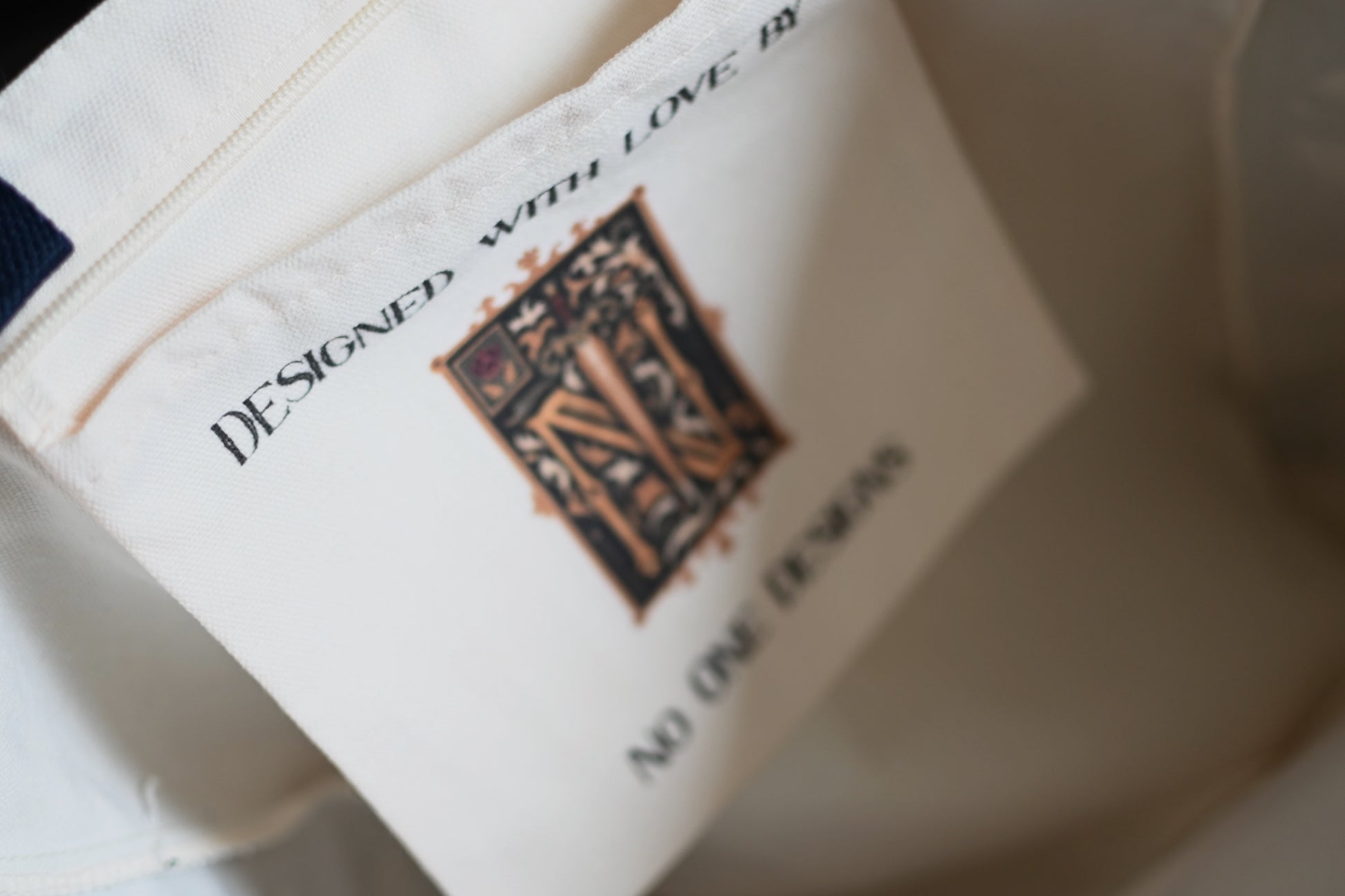 Close-up of a label on a garment with text and a logo.