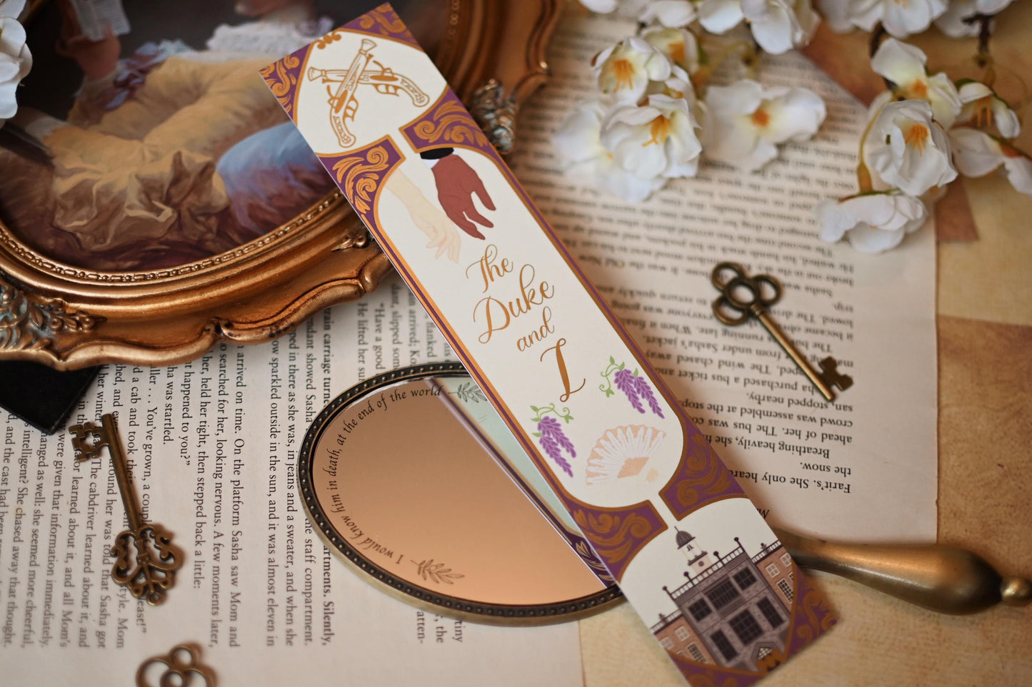 Inspired by The Duke & I, No One Designs bookspine bookmark features the bookmark against a background of bookpages. The bookmark includes illustrations of the Daphne and Simon's almost touching hands, lavendar and Simon's home and gold foil detailing.