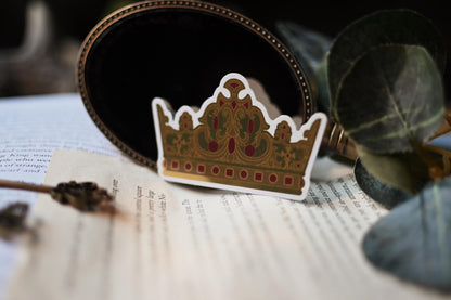 Inspired by V.E Schwab's A Darker Shade of Magic trilogy, a close up of Rhy's Golden Crown sticker shows of the gold detailing and shiny finish.