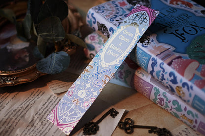 Distance potograph of the once upon a broken heart inspired bookmark with the light reflecting to showcase the intricate gold detailing.