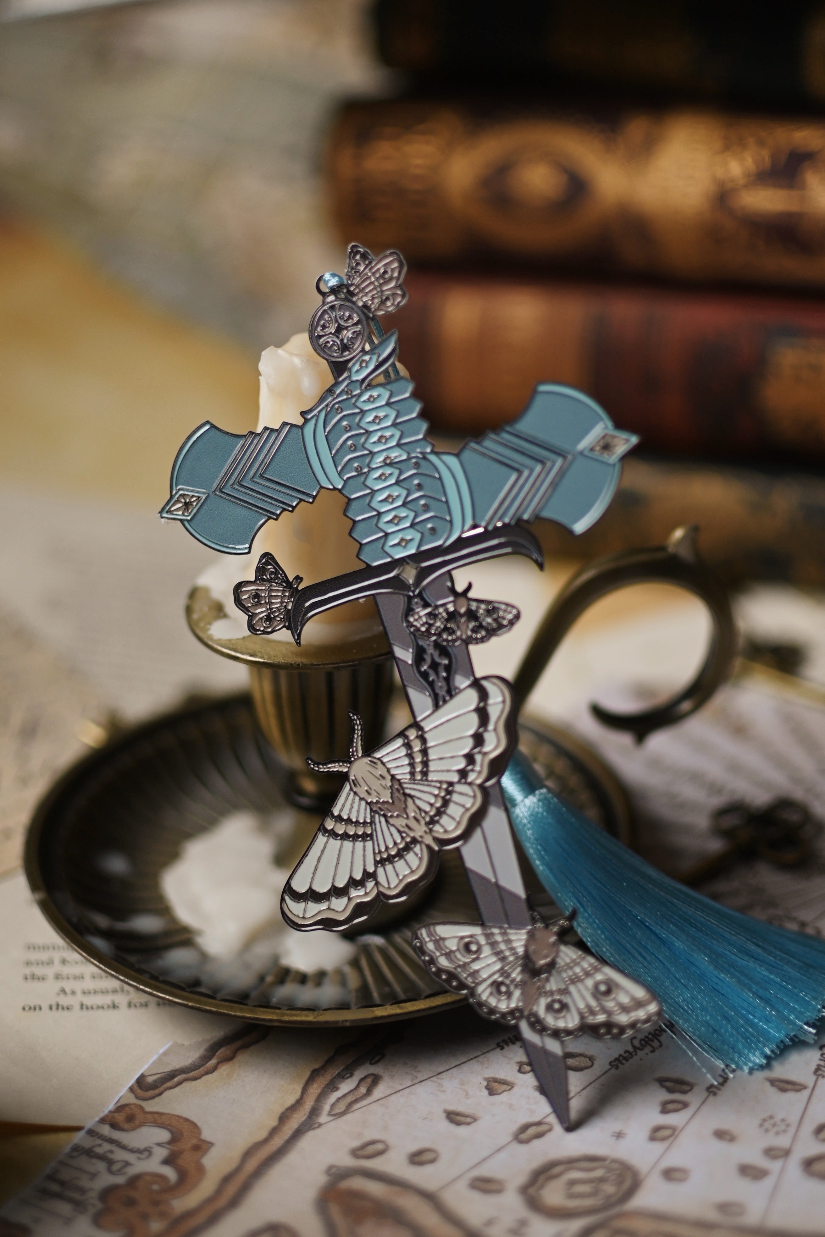 Decorative bookmark inspired by The Knight and the Moth by Rachel Gillig with intricate designs on a textured surface