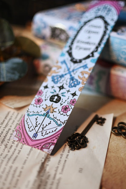 A close-up photograph of the No One Designs bookspine bookmark inspired by Once Upon A Broken Heart by Stephanie Garbar featuring subtle detailing of goil foil, glittery and imagery. 