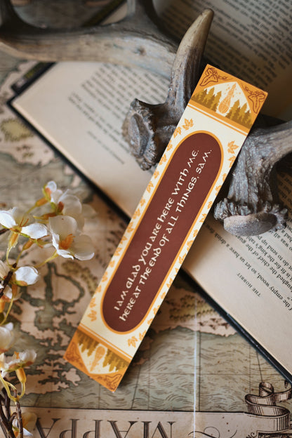 Inspired by The Lord of the Rings, the reimagined book spine series bookmark for The Return of the King sits propped up against an open copy of the book with the quote: I am glad you are here with me. Here at the end of all things Sam."